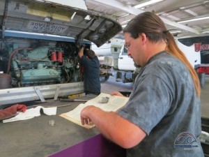 Chris helping our tech quickly get around bus specific stuff by consulting our original manuals.