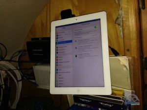 Verizon LTE iPad delicately balanced against the Wilson Sleek 4G cradle. The Top Signal 55 and WiFiRanger are mounted on the wall to the left.