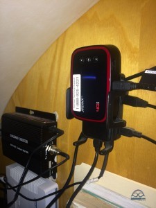 The Pantech MHS291L hotspot sits nestled in the Wilson Sleek 4G-V boosting cradle. In the background you can see the Top Signal booster, and the WiFiRanger.