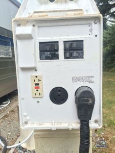 A typical RV power pedestal - delivering 20A (2400W), 30A (3600W), and 50A (6000Wx2).