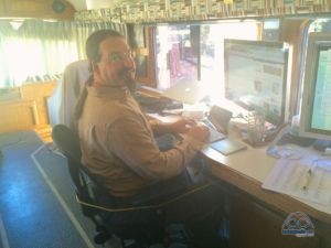 Chris strapped into his desk for a day of writing about solar.