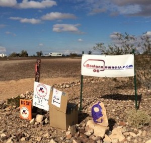 Signs to various encampments in the desert. 