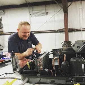 Tim installing an A/C (shoe captions welcomed!)