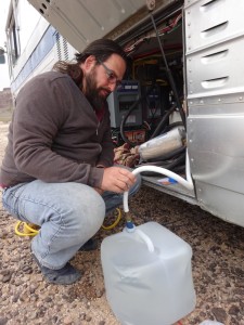 Sucking in fresh water from a collapsable water carrier. 