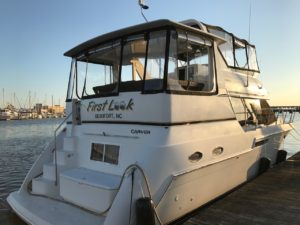 This Carver 406 has a spacious sundeck that can be sealed off from bad weather, and convenient stairs down to a swim platform for easy boarding.